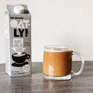 oatly-oat-milk-carton-next-to-a-hut-drink
