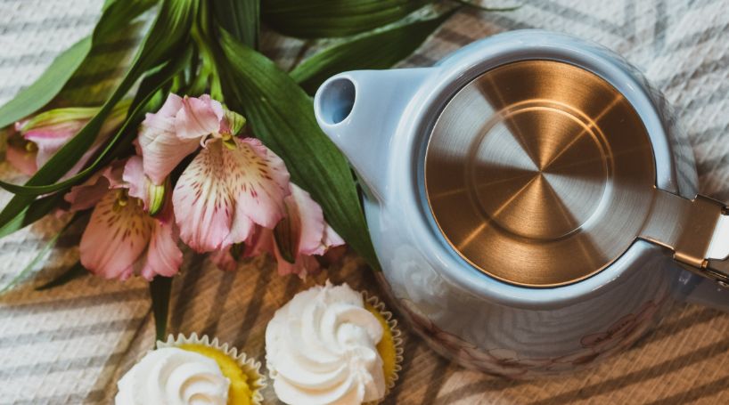 white tea pot and cakes for afternoon tea