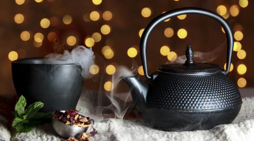 photo of black tea pot with black tea cup.