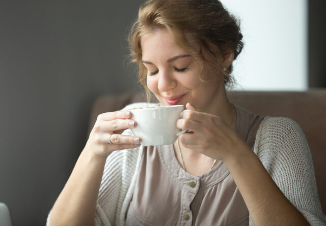 Woman sipping delicious cup of tea