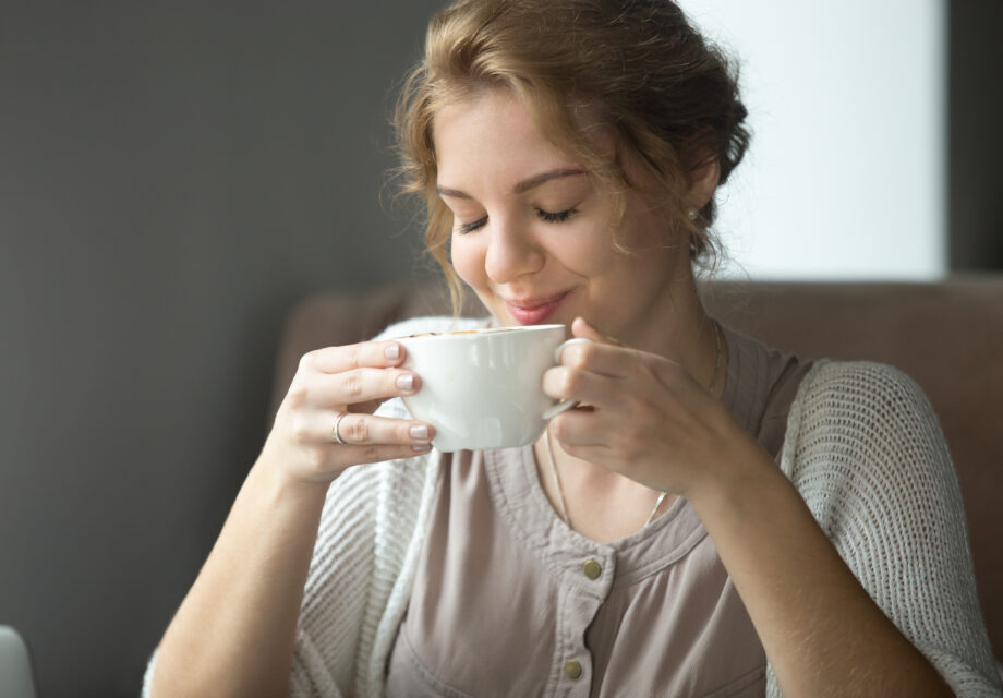 Woman sipping delicious cup of tea