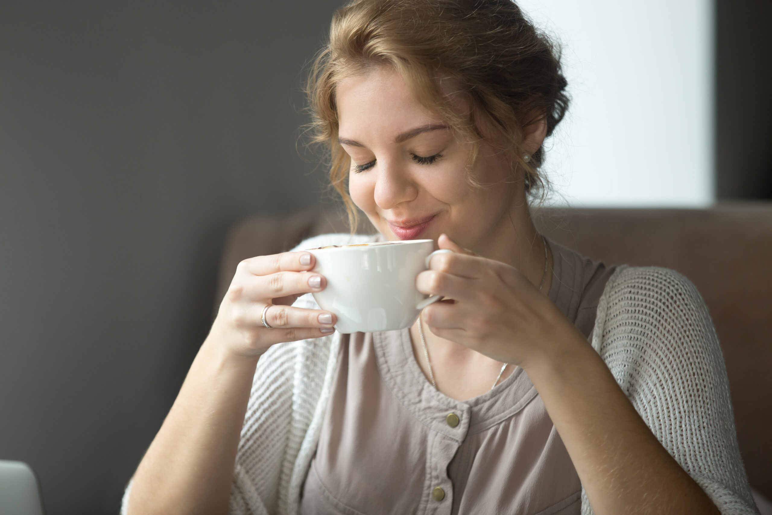 Woman sipping delicious cup of tea